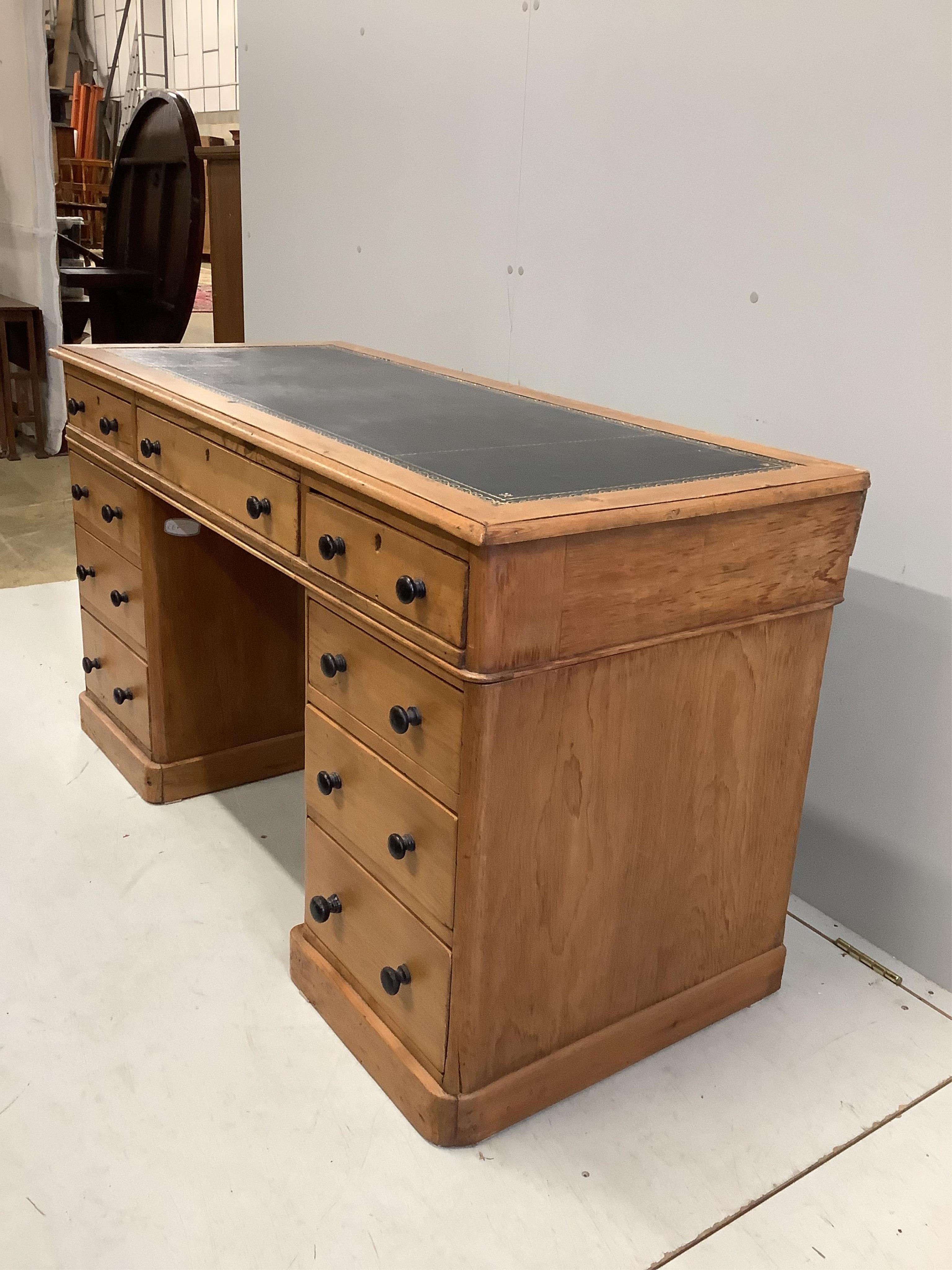 A late Victorian pine pedestal desk, width 131cm, depth 57cm, height 73cm. Condition - fair.